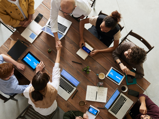 an overhead shot of 8 people at a conference table