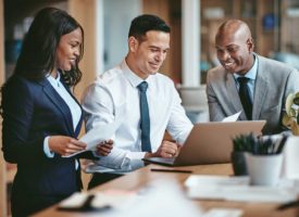 Three business people viewing a document